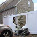 The siding on the home melted by the fire.