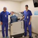 Dr. Christian Dee, left, and Dr. John Carroll show off the new robotic tech at Tobey Hospital. 