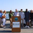 A group of attendees stand for a photo on Onset Pier before cutting the ribbon on the shuttle service.