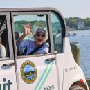 Karen Butler waves while taking a ride in the shuttle.