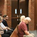 Chadwick's family members and Select Board member Judith Whiteside, center in the leftmost row, watch the proceedings. 