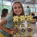 Nova Lomp with her three trophies for artwork, writing and "best in show."