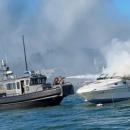 A Wareham Department of Natural Resources vessel douses the burning boat with a water cannon on Saturday, Aug. 8. Photo source: Wareham Department of Natural Resources