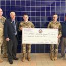 Col. Matt Stanton and JRTOC cadets Aaron Legg and Emily Morais accept a donation toward the town's Veterans Day Parade. Photo source: Nora Bicki
