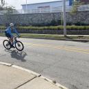 A rider passes Tobey Hospital. 