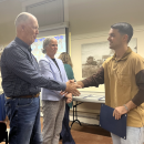 Special education teacher Cameron Decas shakes School Committee Chair Geoffrey Swett's hand. Photos by Tanvi Kulkarni
