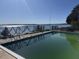  In the coastal enclave of Dolphin's Cove, 22 Spindrift Lane offers a truly rare waterfront setting defined by unobstructed views and a private stretch of beach - an increasingly scarce combination on Cape Cod. 