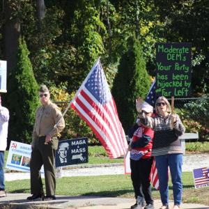 Counter-protestors wave signs of their own.
