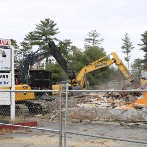 Two excavators are hard at work on the building.
