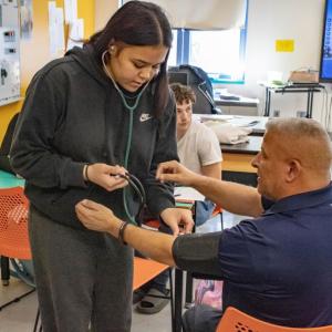 Alivia Benitez-Gaudette practices on instructor Daniel Pina. Photos by Brandy Muz