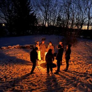 The group gathers around the fire. Photos by Brandy Muz