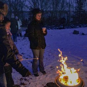 The Roux family gathers for s'mores.