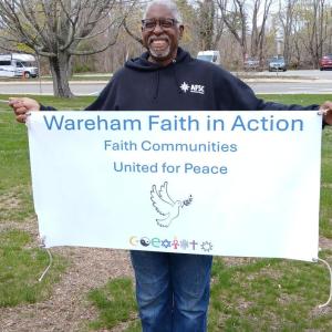 Wareham Faith and Action member beams with a banner. Photos source: Nancy Cushman Rice