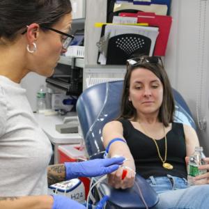 Phlebotomist Ashley Williams, left, prepares to draw Scotlyn LaRue's blood for the drive benefiting Boston Children's Hospital.