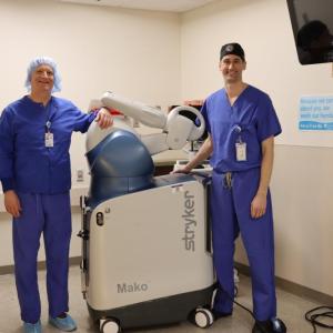 Dr. Christian Dee, left, and Dr. John Carroll show off the new robotic tech at Tobey Hospital. 