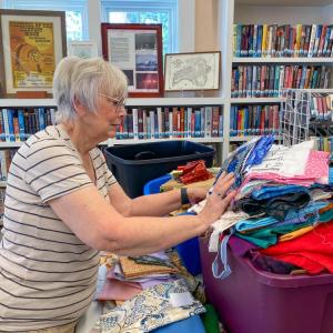 Jane Haupt sorts through a growing mountain of fabrics.