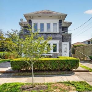 Street view of 370 Maple Street in New Bedford's West End, with its front walk and hedges