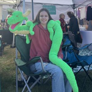 Elisa Campanini shows off her handmade dragon puppet.