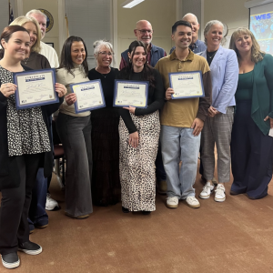 Fourteen district teachers received professional status.