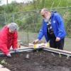 Dixie and Matthew Hill work in their community garden bed at Damien’s Pantry in 2024. File photo