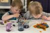 2 Children diligently painting 